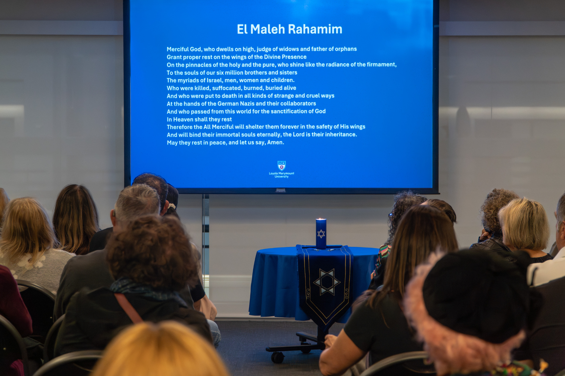 Audience Saying Prayer on Screen